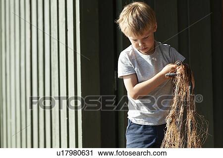 Boy holding up tangled fishing net View Large Photo Image Stock Image - Boy holding up tangled fishing net. Fotosearch