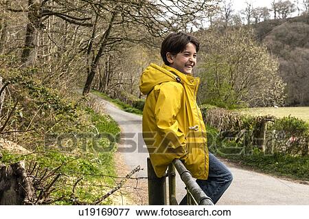 Boy playing in countryside View Large Photo Image Stock Photo - Boy playing in countryside. Fotosearch