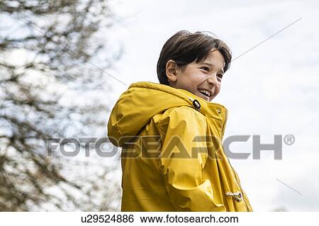 Stock Photograph - Boy playing in countryside. Fotosearch