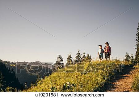 Boys enjoying view on hilltop, Bludenz, Vorarlberg, Austria View Large Photo Image Stock Image - Boys enjoying view on hilltop, Bludenz, Vorarlberg, Austria. Fotosearch