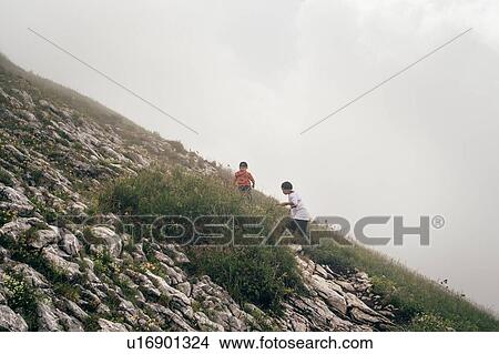 Boys hiking in thick fog on hilltop View Large Photo Image Picture - Boys hiking in thick fog on hilltop. Fotosearch