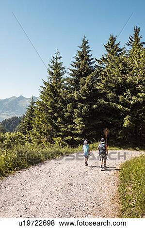 Stock Photo - Boys hiking on trail, Bludenz, Vorarlberg, Austria. Fotosearch