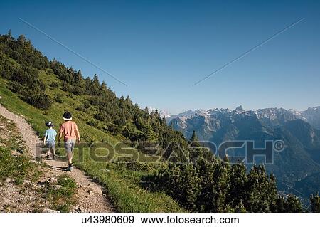 Stock Photo - Boys hiking on trail, Bludenz, Vorarlberg, Austria. Fotosearch