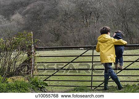 Stock Photo - Brothers playing in countryside. Fotosearch