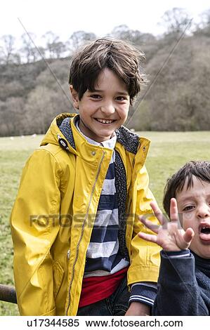 Stock Photography - Brothers playing in countryside. Fotosearch