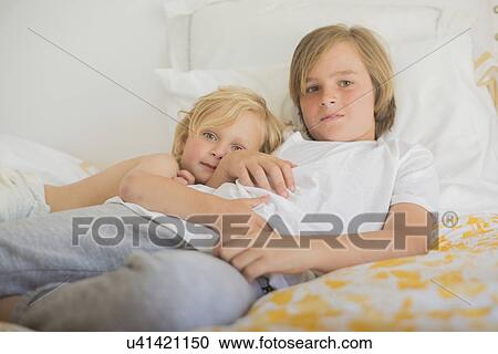 Brothers resting in bed View Large Photo Image Stock Image - Brothers resting in bed. Fotosearch