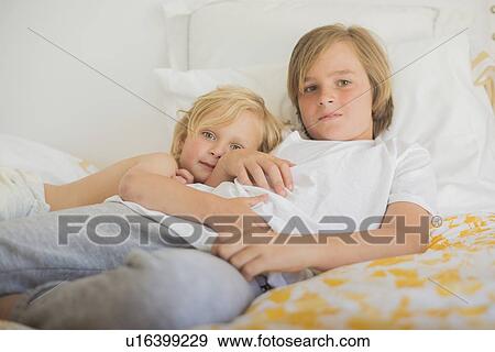 Brothers resting in bed View Large Photo Image Stock Photo - Brothers resting in bed. Fotosearch