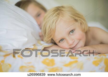 Brothers resting in bed View Large Photo Image Stock Photo - Brothers resting in bed. Fotosearch