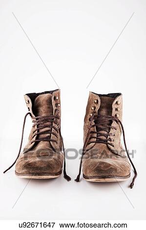 Brown worn vintage boots with untied laces in studio View Large Photo Image Stock Photo - Brown worn vintage boots with untied laces in studio. Fotosearch