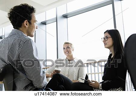 Businessman and businesswomen at meeting in office View Large Photo Image Stock Photo - Businessman and businesswomen at meeting in office. Fotosearch