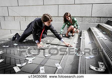 Businessman and woman collecting money on steps View Large Photo Image Stock Photograph - Businessman and woman collecting money on steps. Fotosearch