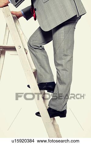 Businessman climbing ladder View Large Photo Image Picture - Businessman climbing ladder. Fotosearch