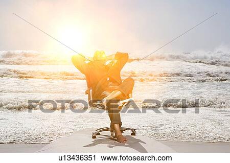 Businessman Sitting in an Office Chair at the Beach View Large Photo Image Stock Image - Businessman Sitting in an Office Chair at the Beach. Fotosearch