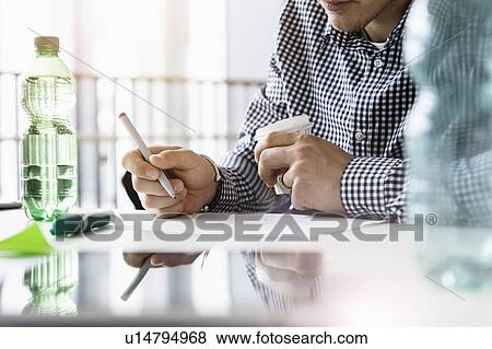 Businessman working in office View Large Photo Image Stock Photo - Businessman working in office. Fotosearch
