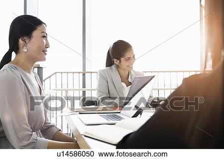 Businesspeople having meeting in office View Large Photo Image Stock Image - Businesspeople having meeting in office. Fotosearch