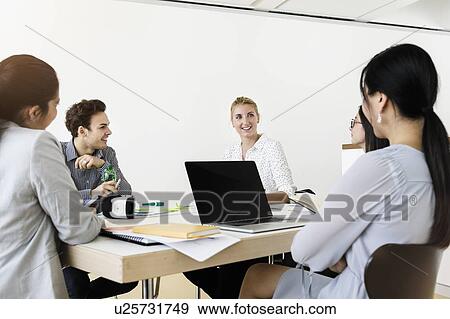 Businesspeople having meeting in office View Large Photo Image Stock Photo - Businesspeople having meeting in office. Fotosearch