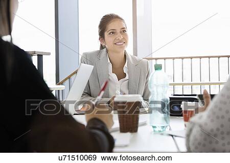 Businesspeople having meeting in office View Large Photo Image Stock Photo - Businesspeople having meeting in office. Fotosearch