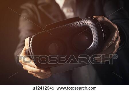 Businesswoman offering VR goggles View Large Photo Image Stock Photography - Businesswoman offering VR goggles. Fotosearch