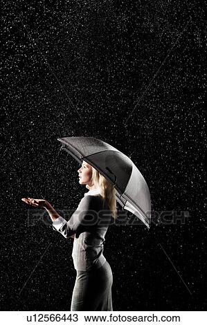 Businesswoman Standing Under Umbrella in rain View Large Photo Image Stock Image - Businesswoman Standing Under Umbrella in rain. Fotosearch