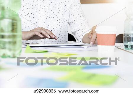 Businesswoman using digital tablet in office View Large Photo Image Stock Photography - Businesswoman using digital tablet in office. Fotosearch