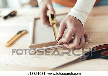 Carpenter measuring picture frame in workshop View Large Photo Image Stock Image - Carpenter measuring picture frame in workshop. Fotosearch