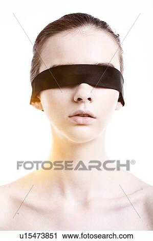 Stock Image - Caucasian woman wearing blindfold. Fotosearch