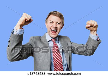 Stock Photo - Celebrating businessman punching the air in celebration. Fotosearch