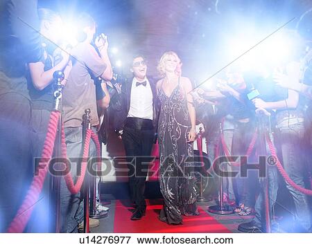 Celebrity couple arriving a premiere with paparazzi cameras and flashes View Large Photo Image Stock Photo - Celebrity couple arriving a premiere with paparazzi cameras and flashes. Fotosearch