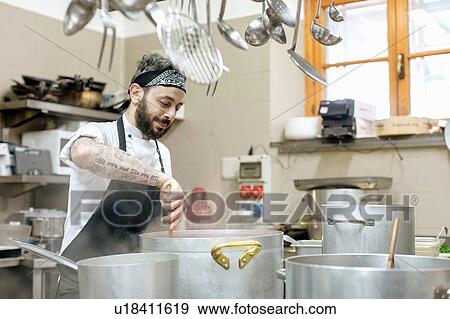 Chef cooking in kitchen View Large Photo Image Stock Photo - Chef cooking in kitchen. Fotosearch