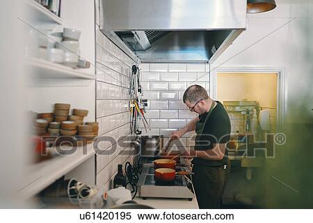 Chef preparing food in kitchen View Large Photo Image Stock Photography - Chef preparing food in kitchen. Fotosearch