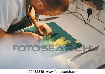 Stock Photography - Chef preparing food in kitchen. Fotosearch
