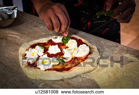 Chef preparing pizza in kitchen View Large Photo Image Stock Photo - Chef preparing pizza in kitchen. Fotosearch