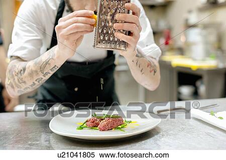 Chef preparing raw meat dish in kitchen View Large Photo Image Stock Photography - Chef preparing raw meat dish in kitchen. Fotosearch