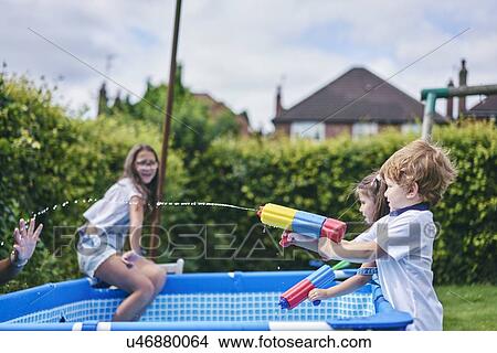 Children playing with water gun by pool View Large Photo Image Picture - Children playing with water gun by pool. Fotosearch