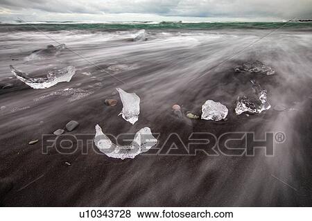 Stock Photo - Chunks of ice resembling diamonds, Jokulsarlon beach (Diamond beach), Iceland. Fotosearch