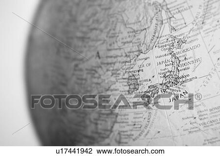 Stock Image - Close up black and white photo of Japan on Globe. Fotosearch