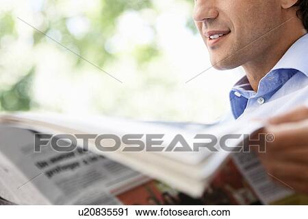 Stock Image - Close up of Man Reading Newspaper. Fotosearch