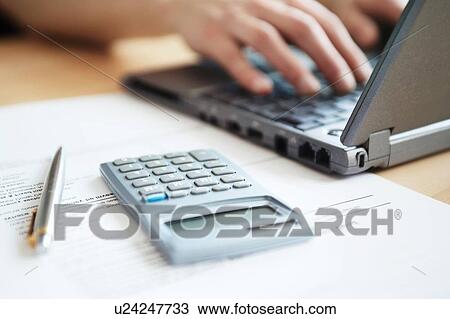 Close up of someone working on accounts at desk View Large Photo Image Stock Image - Close up of someone working on accounts at desk. Fotosearch