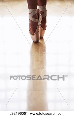 Close up on ballerina on pointe in pointe shoes View Large Photo Image Stock Image - Close up on ballerina on pointe in pointe shoes. Fotosearch