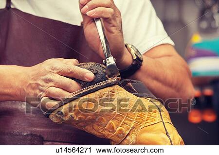 Cobbler craftsman fixing leather boot using tools View Large Photo Image Stock Image - Cobbler craftsman fixing leather boot using tools. Fotosearch