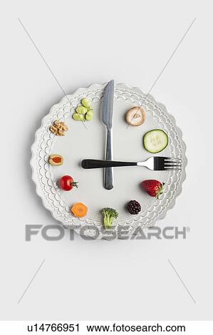 Conceptual image of a food clock View Large Photo Image Stock Image - Conceptual image of a food clock. Fotosearch