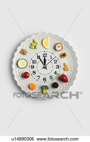 Conceptual image of a food clock View Large Photo Image Stock Photograph - Conceptual image of a food clock. Fotosearch