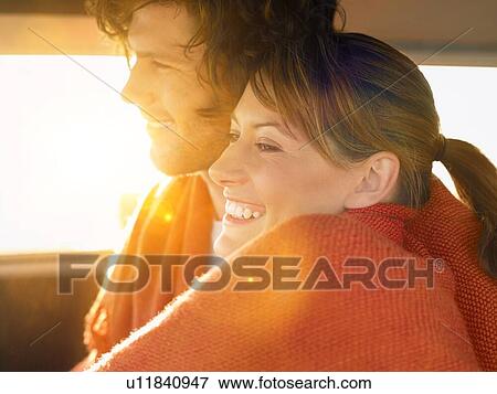 Couple Cuddling in Van under blanket View Large Photo Image Stock Photo - Couple Cuddling in Van under blanket. Fotosearch