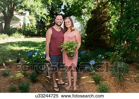 Stock Photography - Couple gardening in backyard. Fotosearch