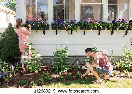 Couple gardening in front porch View Large Photo Image Stock Photo - Couple gardening in front porch. Fotosearch