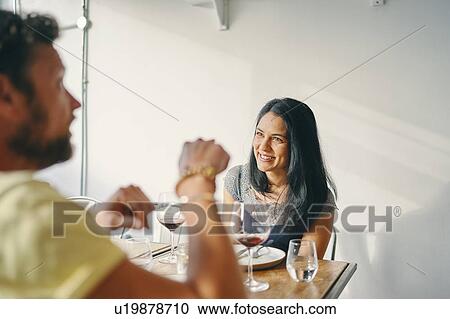 Stock Image - Couple having meal in restaurant. Fotosearch