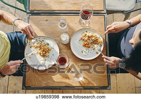 Couple having meal in restaurant View Large Photo Image Stock Photo - Couple having meal in restaurant. Fotosearch