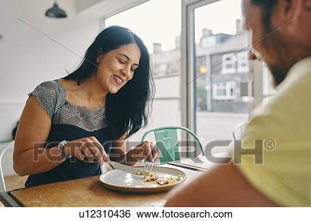 Couple having meal in restaurant View Large Photo Image Stock Photograph - Couple having meal in restaurant. Fotosearch