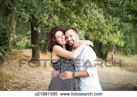 Stock Photography - Couple hugging in park. Fotosearch
