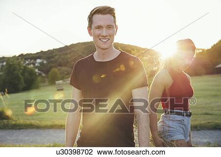 Stock Image - Couple in countryside in sunshine, Wilhelminenberg, Vienna, Austria. Fotosearch